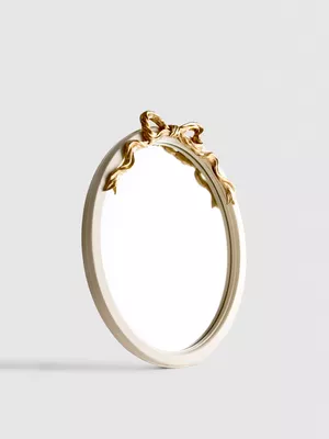 Espejo ovalado con detalle de lazo