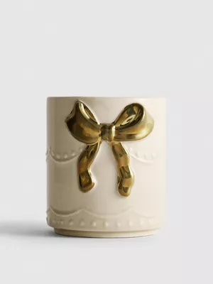 Vela aromática en recipiente con lazo