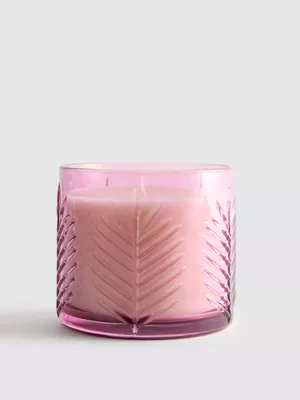 Vela aromática en tarro de vidrio con hojas de palma