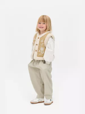 1,5-8 años | Chaleco bordado con ribete de borrego